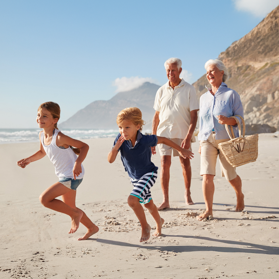 Grandparents and grand kids walking on beach